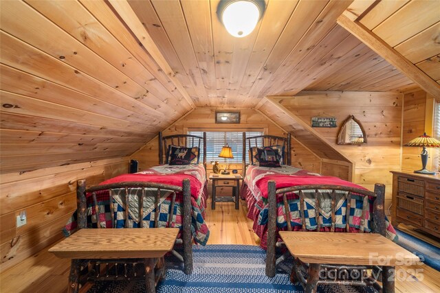 bedroom featuring wood ceiling, wood-type flooring, wooden walls, and vaulted ceiling