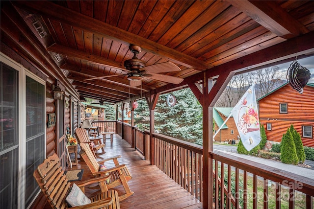 wooden deck with a porch and ceiling fan