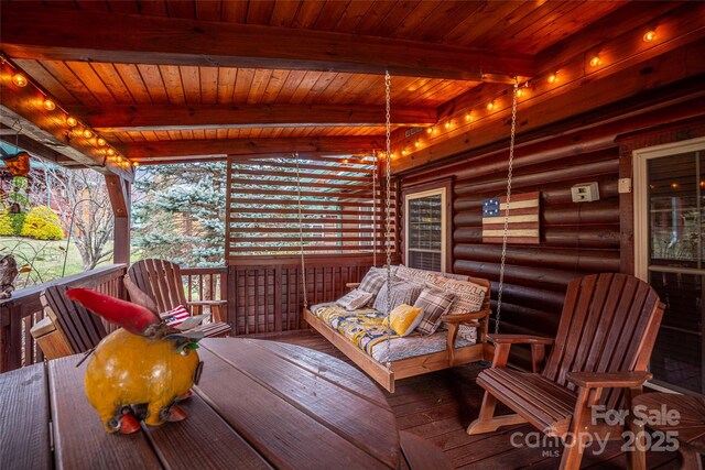 sunroom featuring wood ceiling and beam ceiling