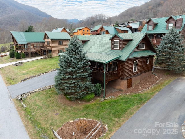 view of front of property with a mountain view and a front lawn