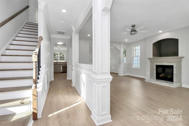 foyer with ceiling fan, ornate columns, and light hardwood / wood-style flooring