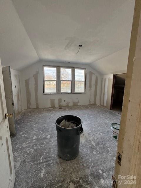 bonus room featuring plenty of natural light and vaulted ceiling