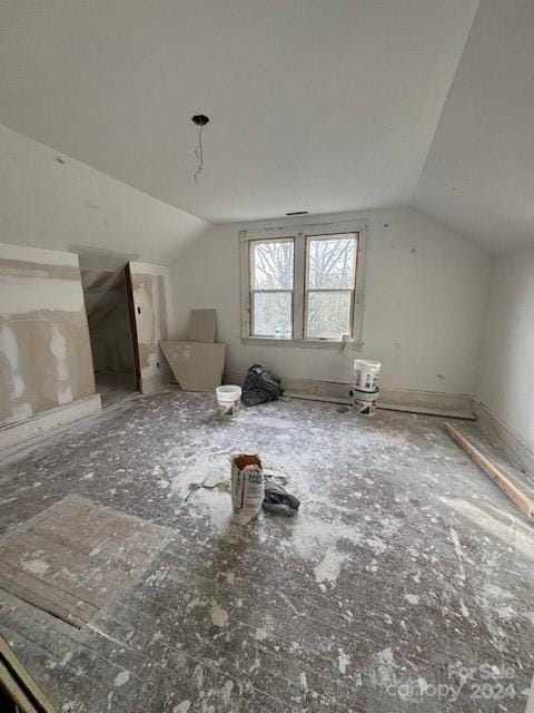 additional living space featuring vaulted ceiling