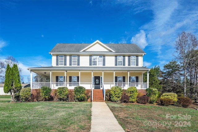 colonial house with a porch and a front lawn