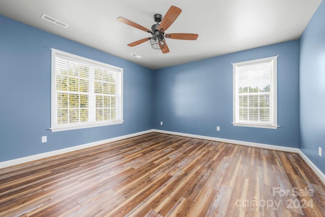 unfurnished room with hardwood / wood-style flooring and ceiling fan