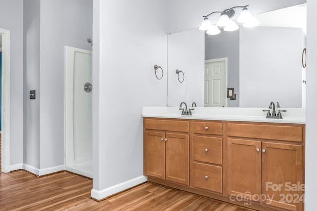 bathroom with vanity, wood-type flooring, and walk in shower