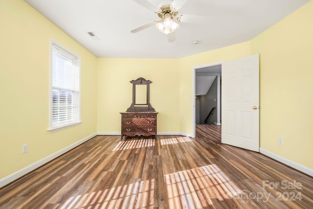 empty room featuring ceiling fan and dark hardwood / wood-style floors