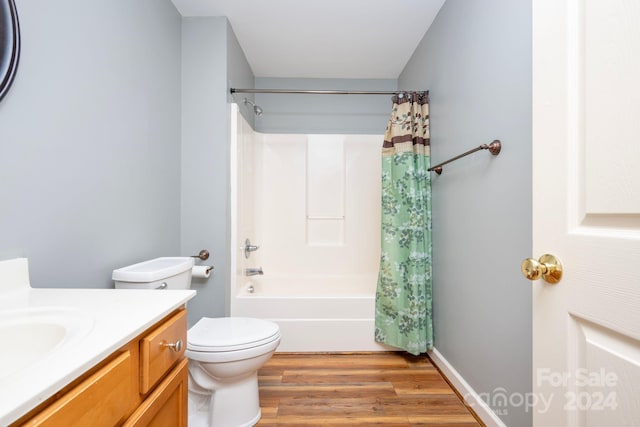 full bathroom featuring vanity, shower / bathtub combination with curtain, wood-type flooring, and toilet