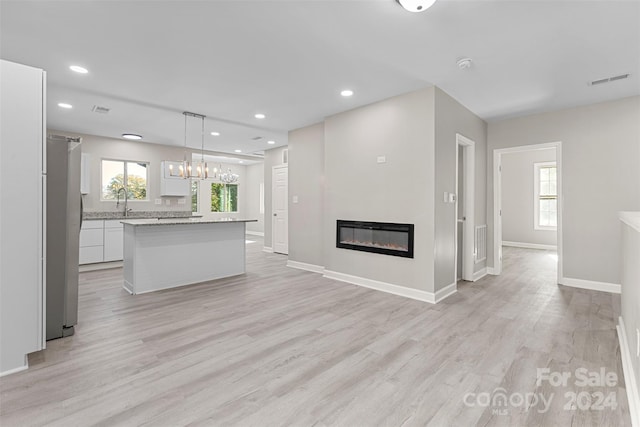 unfurnished living room featuring light hardwood / wood-style floors