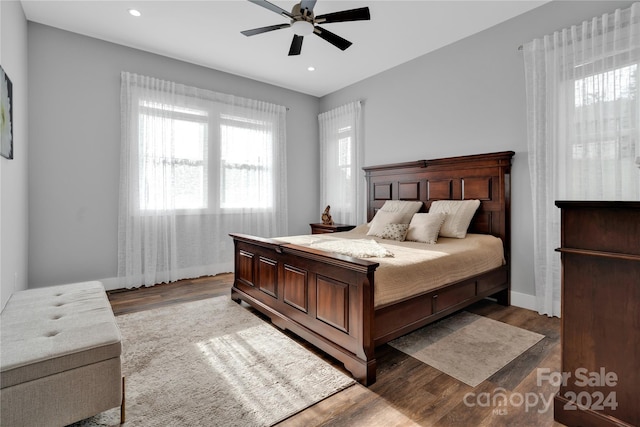 bedroom with ceiling fan and dark hardwood / wood-style flooring