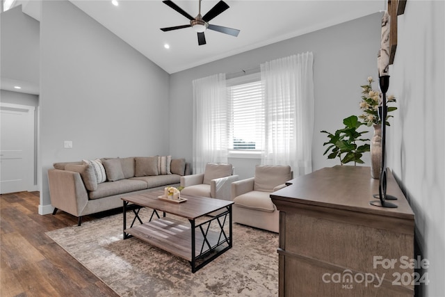 living room featuring ceiling fan, wood-type flooring, and vaulted ceiling