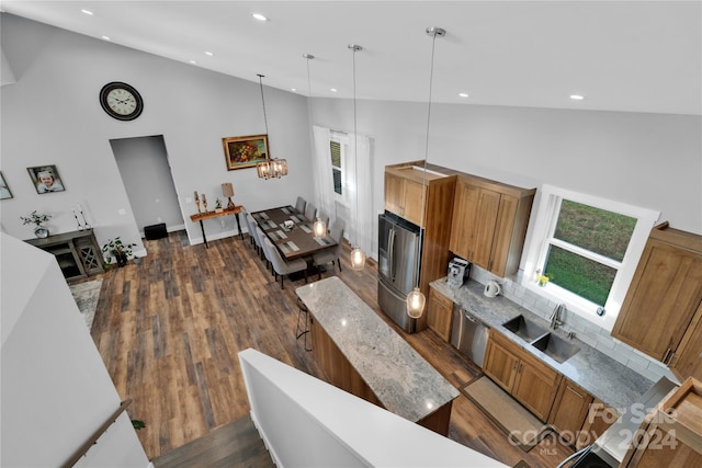 living room featuring dark hardwood / wood-style floors, sink, high vaulted ceiling, and an inviting chandelier