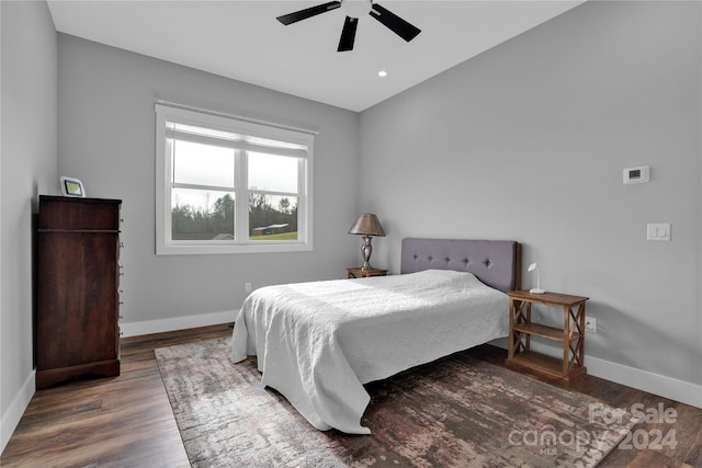 bedroom with wood-type flooring, ceiling fan, and lofted ceiling