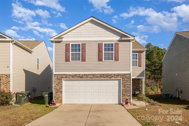 view of front of home with a garage and central AC unit