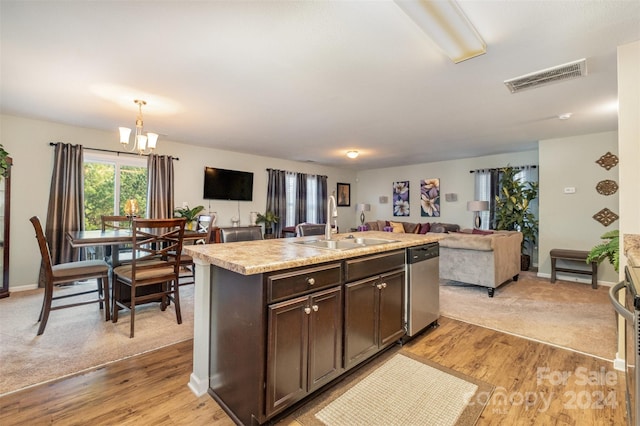 kitchen with dark brown cabinetry, light hardwood / wood-style floors, stainless steel dishwasher, and an island with sink