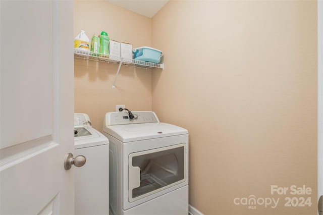 laundry room featuring washing machine and clothes dryer