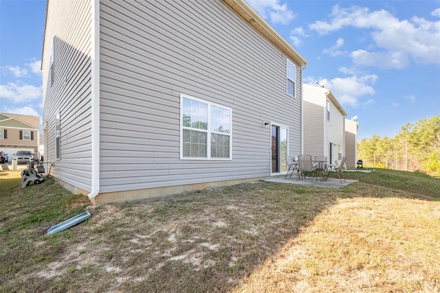 view of property exterior with a patio area and a yard