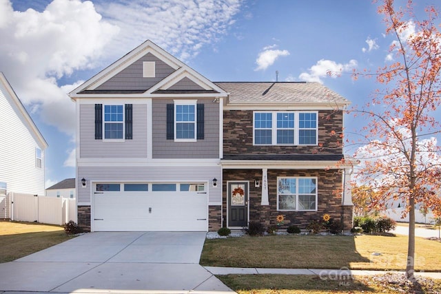 craftsman inspired home featuring a garage and a front yard