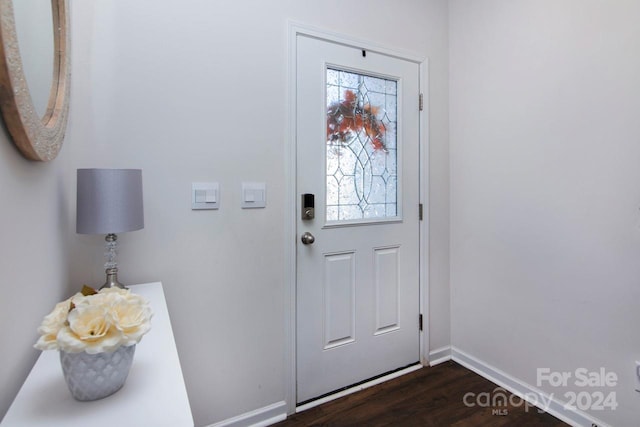 doorway to outside with plenty of natural light and dark wood-type flooring