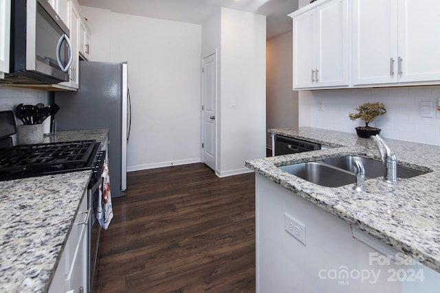 kitchen featuring decorative backsplash, stainless steel appliances, and white cabinetry