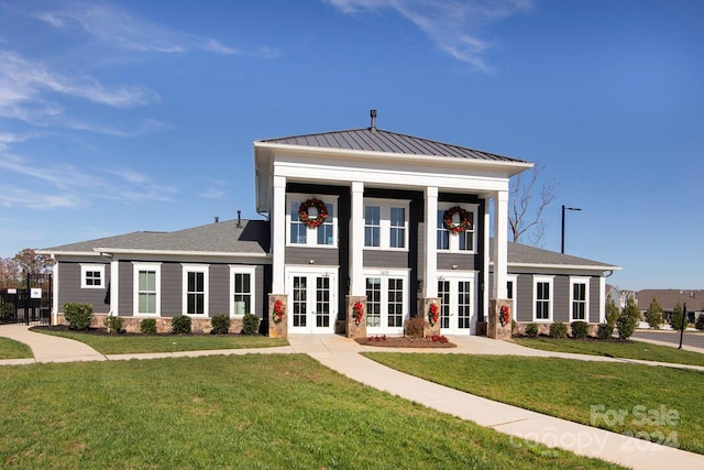 view of front of house featuring french doors and a front lawn