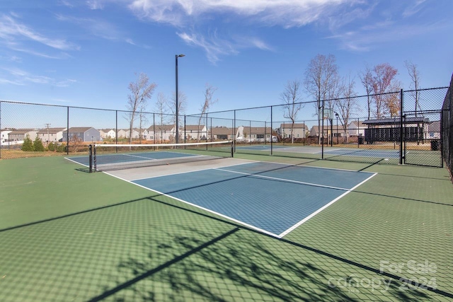 view of tennis court featuring basketball court