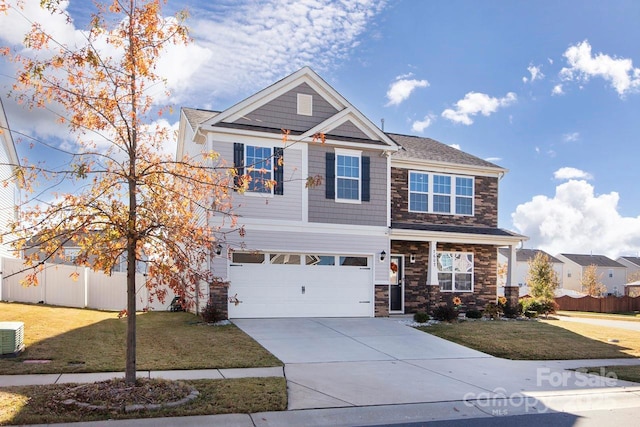 craftsman house with a garage and a front lawn