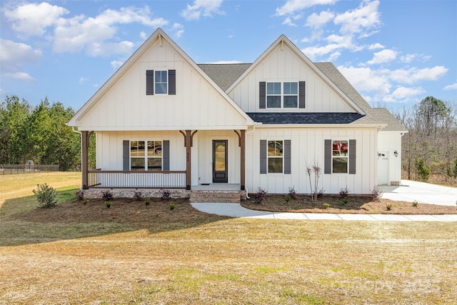 modern farmhouse featuring a shingled roof, a porch, board and batten siding, and a front yard