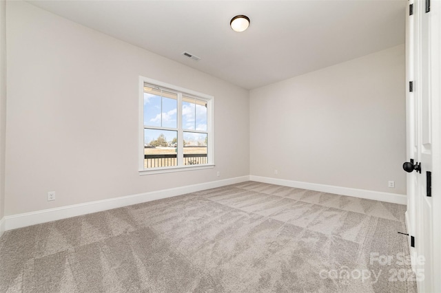 carpeted empty room with visible vents and baseboards