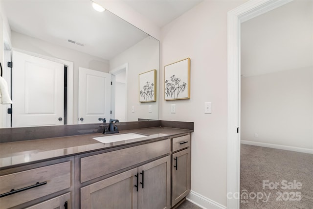 bathroom featuring baseboards, visible vents, and vanity