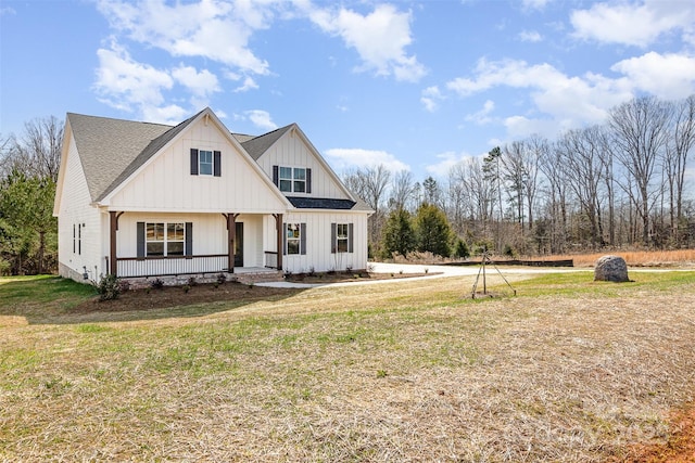 modern farmhouse style home featuring board and batten siding, a front yard, a porch, and a shingled roof