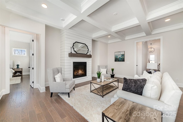 living room featuring coffered ceiling, wood finished floors, and beam ceiling