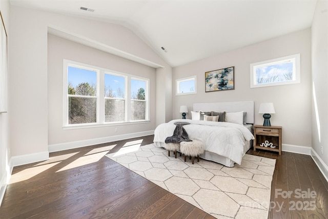 bedroom featuring lofted ceiling, wood finished floors, visible vents, and baseboards