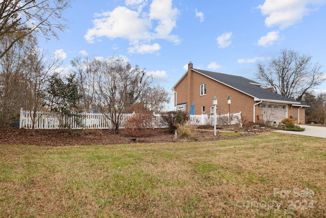 view of property exterior featuring a yard and a garage