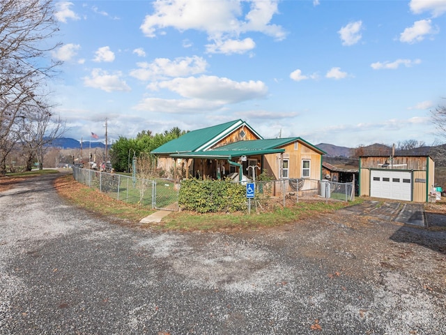 view of front of property featuring a garage and a mountain view