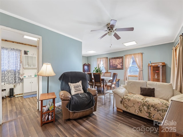 living room featuring ornamental molding, ceiling fan, and dark hardwood / wood-style flooring