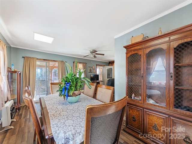 dining area featuring ornamental molding, dark hardwood / wood-style floors, and ceiling fan