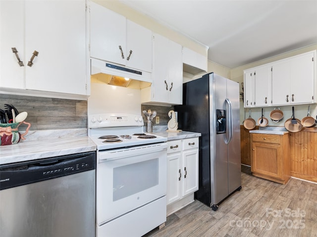 kitchen featuring white cabinetry, decorative backsplash, light hardwood / wood-style floors, and appliances with stainless steel finishes