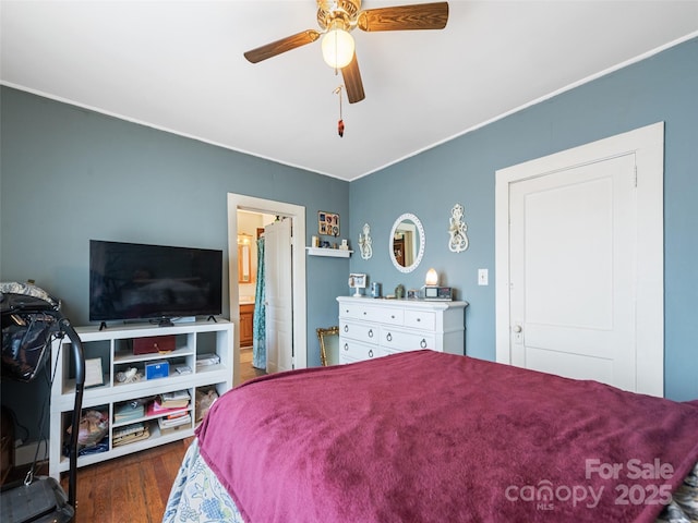 bedroom with ensuite bath, dark hardwood / wood-style floors, and ceiling fan