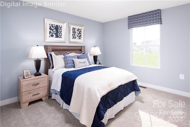 bedroom featuring light colored carpet