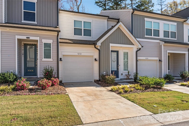 9232 Widden Way, Charlotte, NC 28269 - multi unit property with an attached garage, board and batten siding, concrete driveway, and a front yard