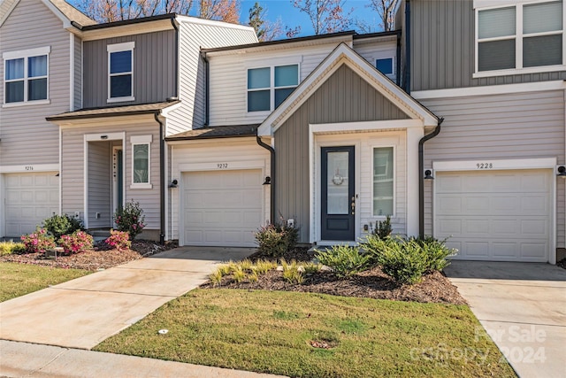 9232 Widden Way, Charlotte, NC 28269 - townhome / multi-family property featuring concrete driveway, board and batten siding, and a garage