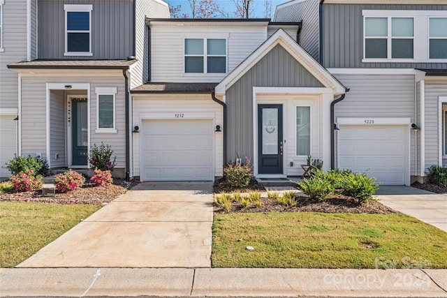 9232 Widden Way, Charlotte, NC 28269 - townhome / multi-family property with board and batten siding, driveway, and a front lawn