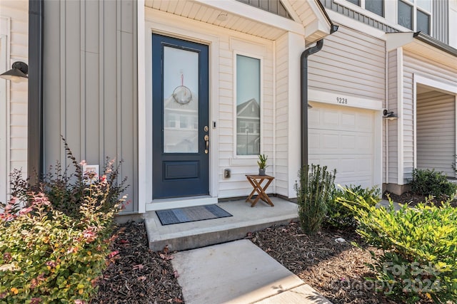 view of exterior entry with a garage