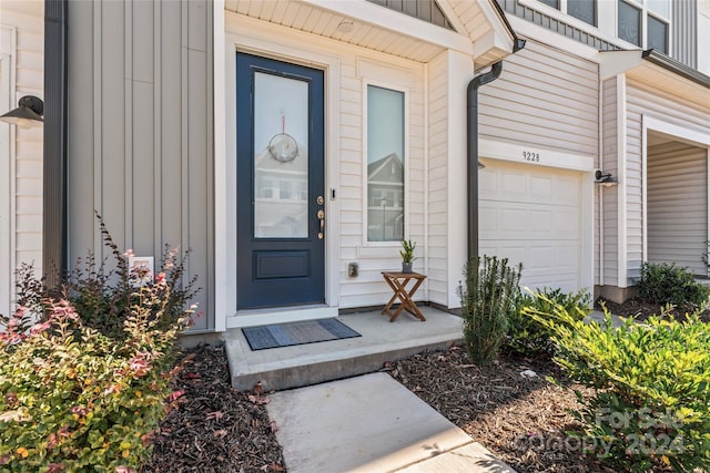 9232 Widden Way, Charlotte, NC 28269 - view of exterior entry featuring board and batten siding and a garage