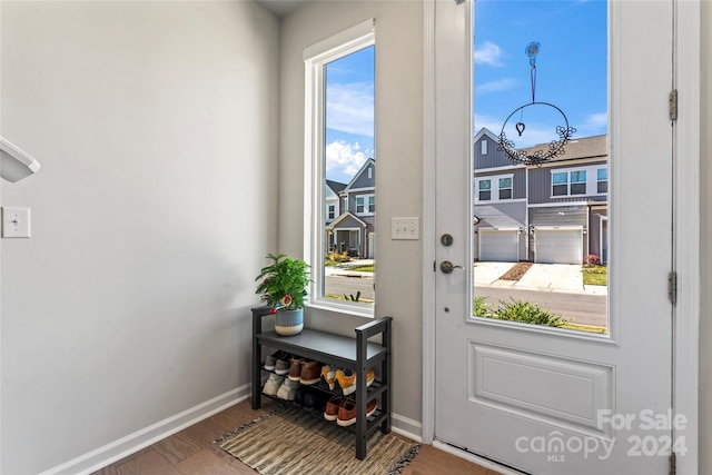 9232 Widden Way, Charlotte, NC 28269 - doorway to outside with a chandelier, baseboards, and wood finished floors