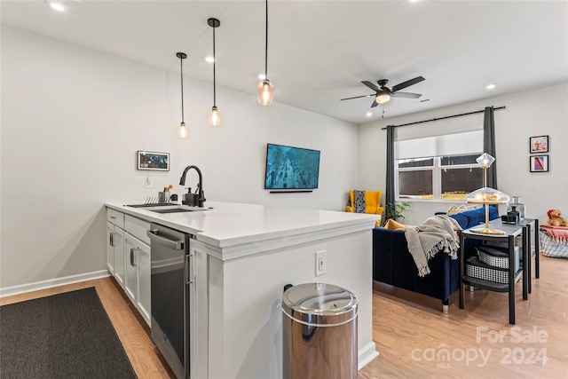 kitchen featuring ceiling fan, sink, decorative light fixtures, light hardwood / wood-style floors, and white cabinetry