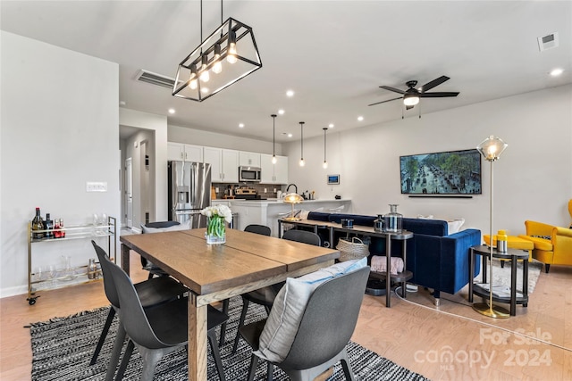 dining area featuring light wood-type flooring and ceiling fan