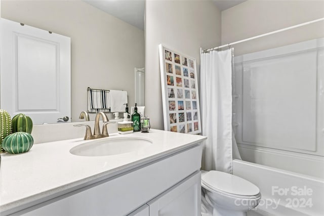 full bathroom with vanity, shower / tub combo, and toilet