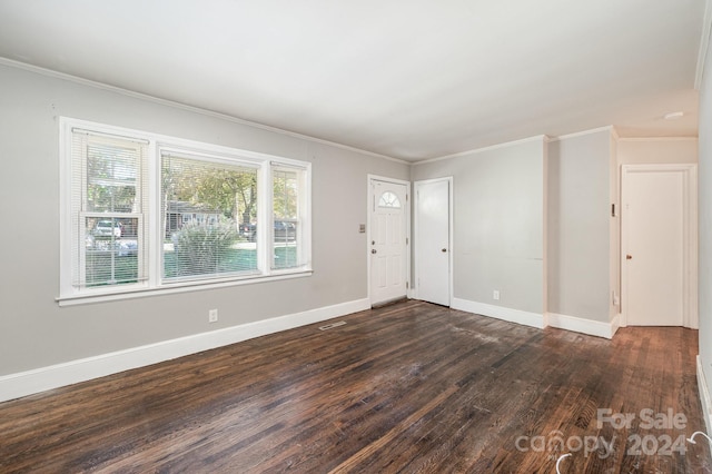 spare room with dark hardwood / wood-style floors and crown molding